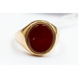A carnelian set 9ct gold dress ring, size R½, total gross weight 9.7gms.
