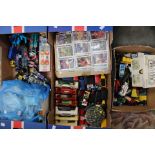 Two boxes of assorted diecast vehicles and Beatrix Potter books and cigarette cards