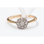 An 18ct gold and diamond daisy ring, centre diamond with eight surrounding, size M, approx 2.