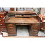 An early 20th Century oak twin pedestal tambour desk