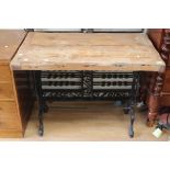 An early 20th Century pine plank top wrought iron table,
