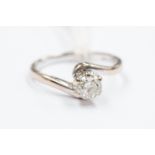 A diamond solitaire 18ct white gold ring, cross-over shoulders,