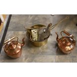 A pair of copper bed warmers with a brass saucepan, pot stand, bellow and table brush,