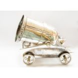 A silver plated novelty wine bottle holder in the form of a Cannon or Mortar on a four wheeled
