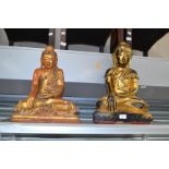 Two early 20th Century wooden gilt sitting Buddha's