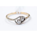 A 9ct gold and diamond two-stone ring, twist setting, size N½, gross weight approx 2.