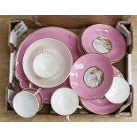An early 20th Century pink ground part tea set with hand painted scenes