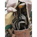 Vintage golf clubs in brown leather bag,