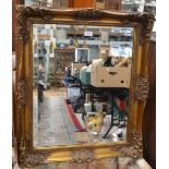 Wall mirror in ornate gilded frame;