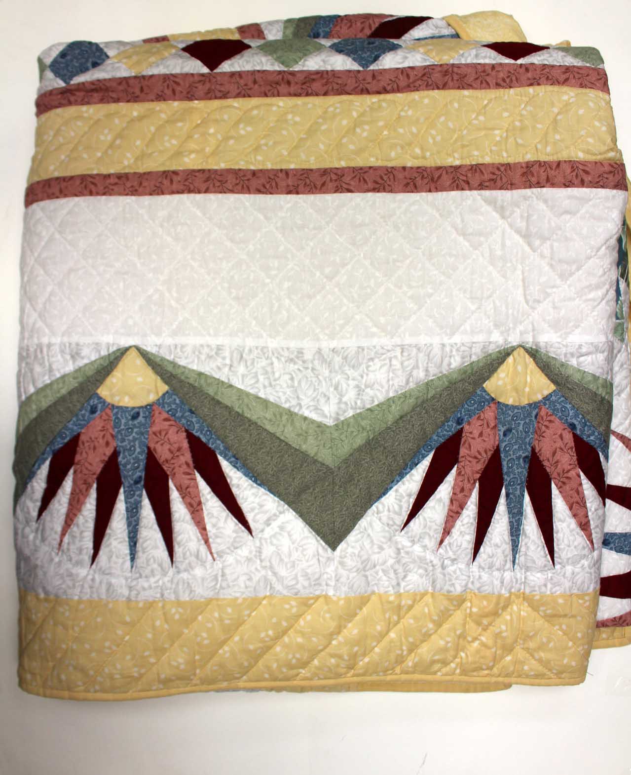 A kingsize quilt made by the ladies of the Amish Community, made in a mariners compass design,