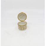 A late - 19th century European hard paste cylinder trinket box, raised gilt scrollwork decoration,