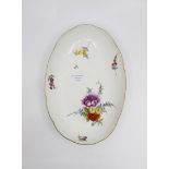 A Meissen oval side dish with altozier relief, a bouquet of flowers and strewn flowers, gilt rim,