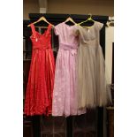 A stunning collection of three dresses to include; a pale grey evening dress,