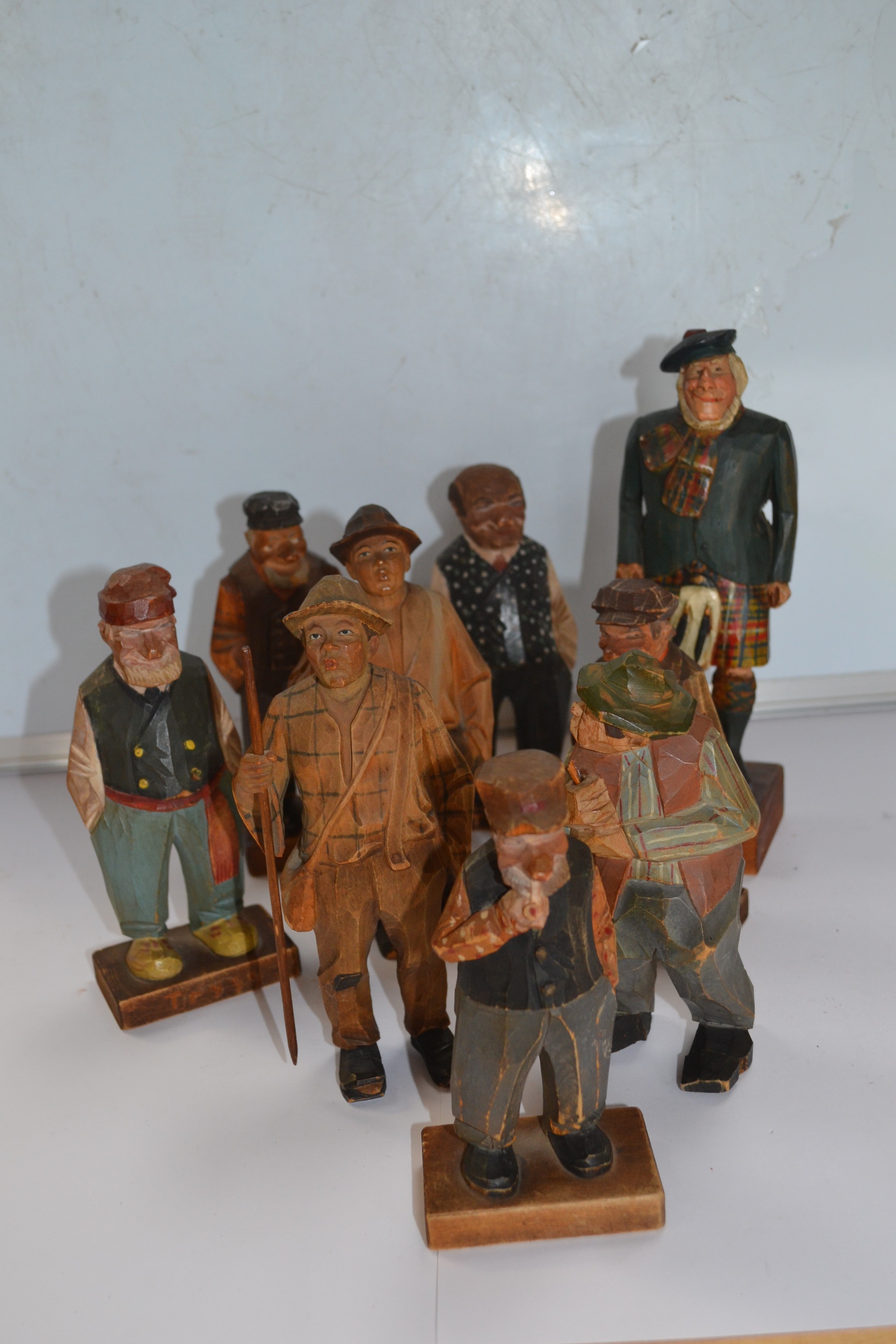 An interesting collection of six Canadian and three Black Forest carved figures (9)