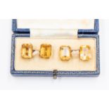 A pair of yellow metal cufflinks, each terminal claw set with rectangular cut citrine, one mount A.