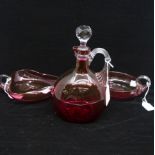 A cranberry glass decanter with stopper and two cranberry bowls with handles (3)