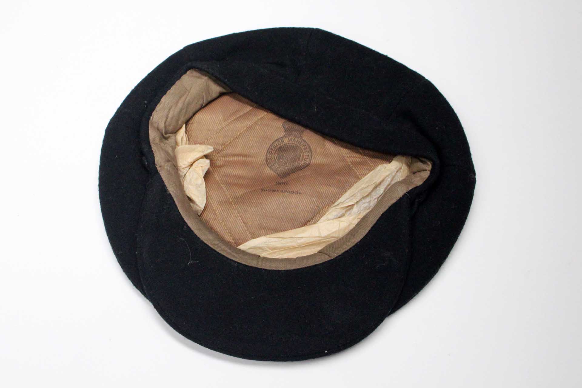 An early 1900's mans working cap, black wool, canvas lining, by Superior Manufacturing Co.