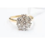A diamond flower head cluster ring,