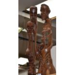 A pair of carved African figures of unusual striking design; one a group of heads and limbs,