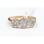 A diamond cluster set dress ring, comprising three cluster settings set with brilliant cut diamonds,