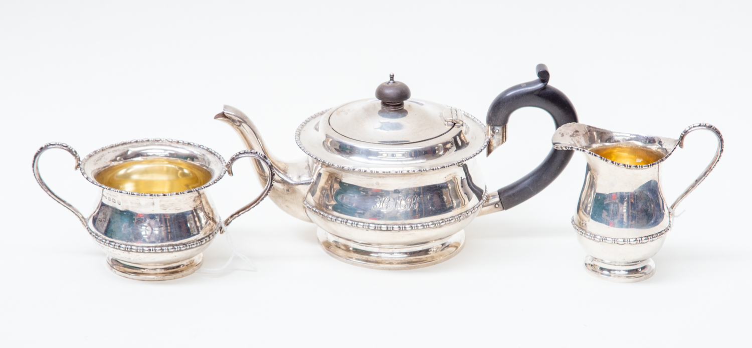 A George V silver three piece tea service, including teapot, sugar bowl and milk jug,