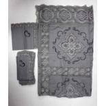 A pale grey hand crocheted tablecloth,