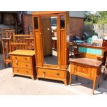 An Edwardian bedroom suite, comprising single door wardrobe, a three drawer chest,