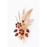 A garnet and citrine set stylized spray brooch,