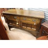 An Art Nouveau oak sideboard, fitted with two drawers over two doors,