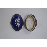 A Bilston cobalt blue enamel snuff box with raised pattern of two love birds in white.