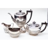 A George V silver tea & coffee service Georgian style with gadroon lower sections, ebonised handles,