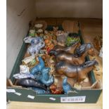 A collection of assorted ceramic figures, including Poole Pottery dolphins, horses,