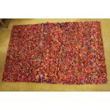 A textured abstract multi coloured hand woven felt rug