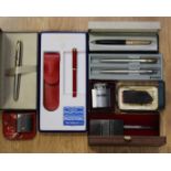 A collection of Parker Pens with two lighters