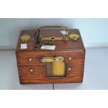 A 1950's unusual oak cased and brass internal, key,