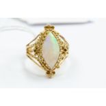 A yellow metal opal, in a fancy setting, size O, tests as approx 14k gold, gross weight approx 6.