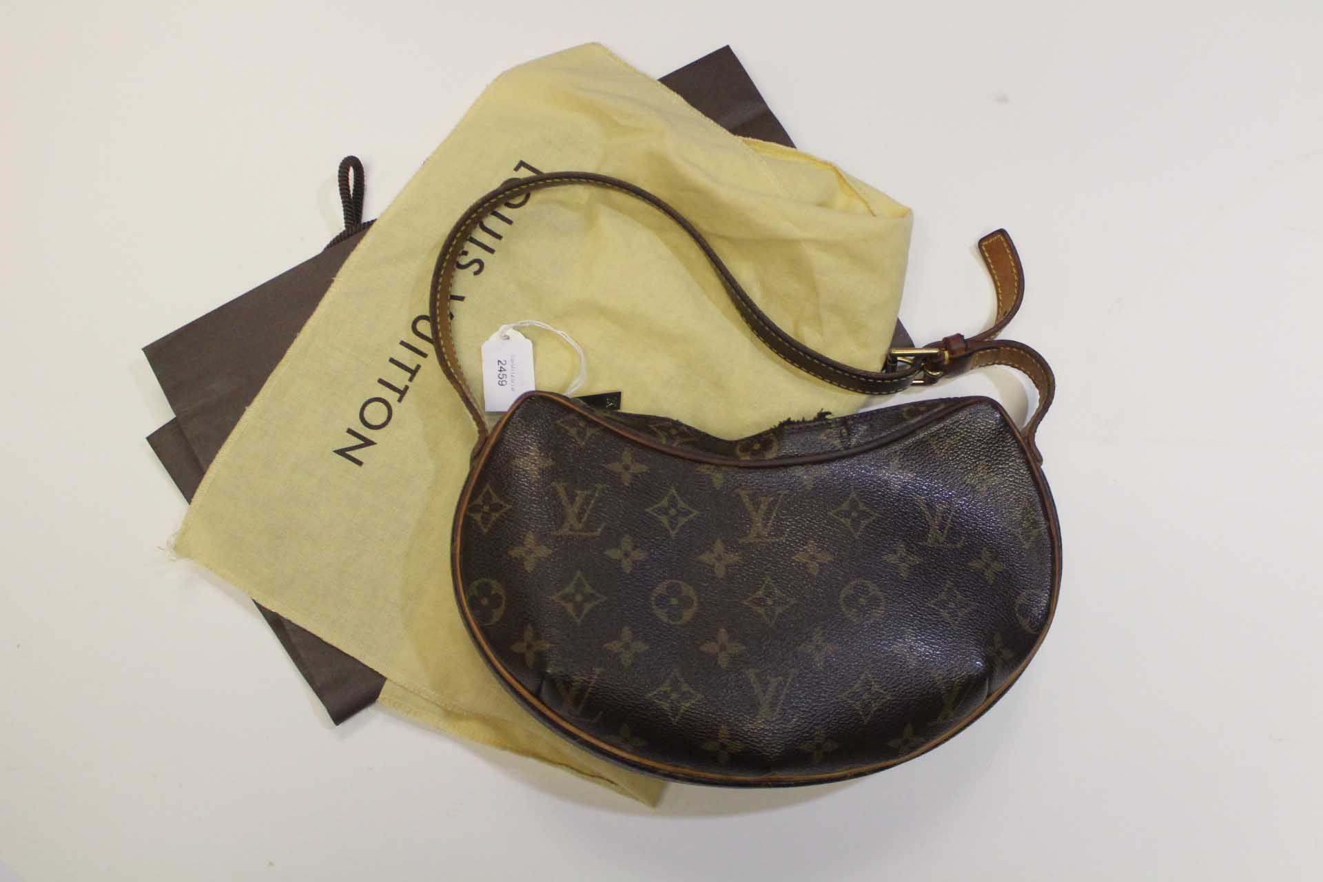 A Louis Vuitton Croissant Bag, monogrammed canvas, 10.5" length approx, shoulder strap, suede lined.