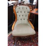 Victorian reproduction button back nursing chair with green upholstery.