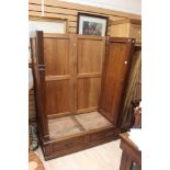An Early 20th Century large oak carved wardrobe on two small drawers.