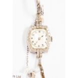 A circa 1940's lady's diamond and platinum cocktail watch,