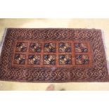 20th century hand woven woolen rug in brown reds and navy blue. warn in places.