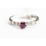 An 18ct white gold, diamond and ruby ring, size Q, gross weight approx 3.