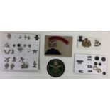 A small collection of Gurhka Rifles cap badges and others, collar dogs, buttons and cloth insignia.