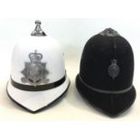 Isle of Man white Police helmet with Queen's Crown badge and a pre 1970 Royal Ulster Constabulary