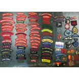 WW2 and later British cloth shoulder titles and formation signs. Over 90 items in total.