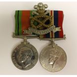 WW2 British Defence Medal and War Medal. Mounted on a bar along with a North Staffs Regt cap badge.