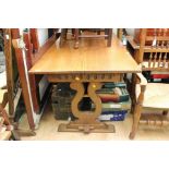 A 20th Century oak refectory type table, raised on baluster shaped trestle ends