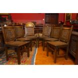 A set of six 19th Century style oak chairs with carved back panels, comprising two carvers and four