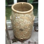 A stoneware twin handled barrel shaped cistern, decorated in raised relief with a coat of arms