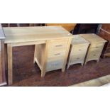 A contemporary four piece oak part bedroom suite, comprising desk and a pair of bedside chests,